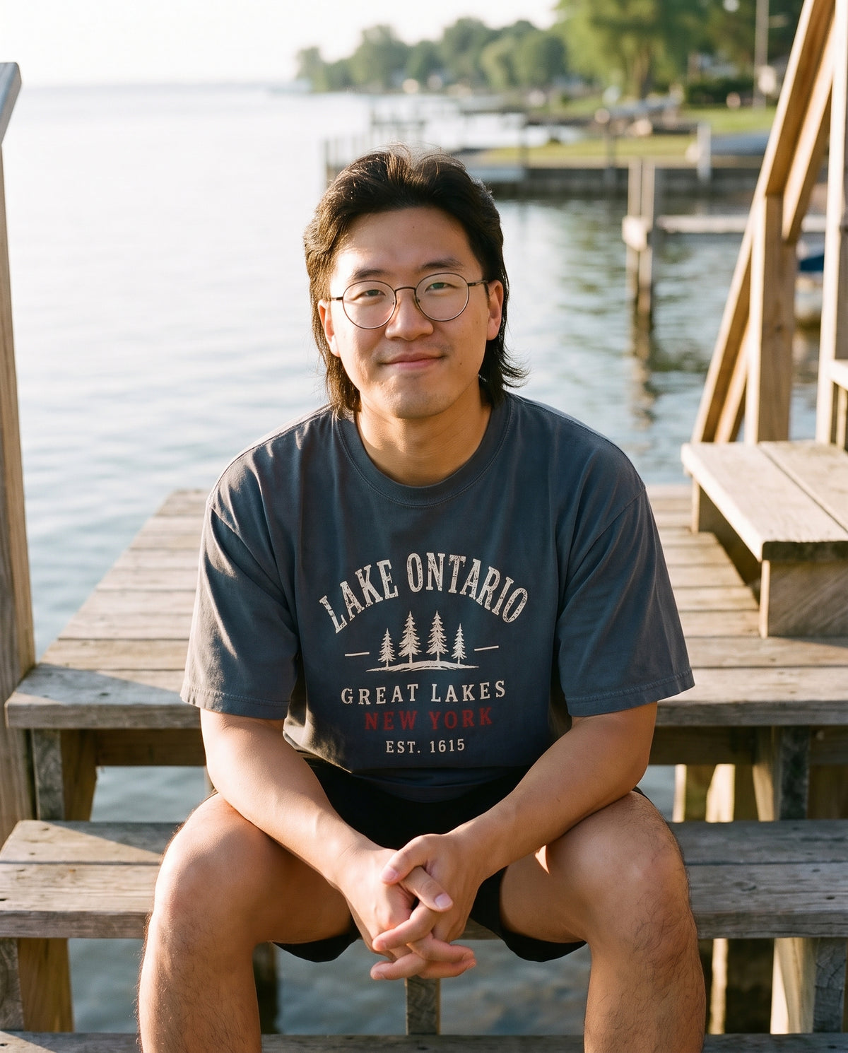 Lake Ontario Great Lakes tee in Black on a Sodus Bay boathouse stair