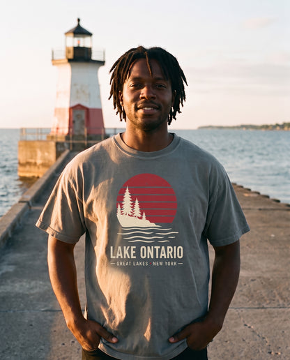 Lake Ontario Sunset tee in Grey, worn on the Oswego harbor breakwall