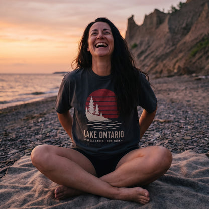 Lake Ontario Sunset tee in Black, worn on the beach at Chimney Bluffs