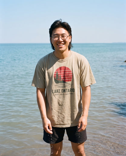 Sunset Tee in Khaki, worn on the shore of Lake Ontario